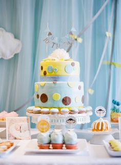 there is a cake and cupcakes on the table at this baby's first birthday party