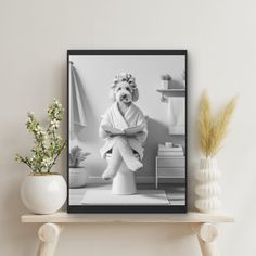 a black and white photo of a dog in a bathrobe on a shelf