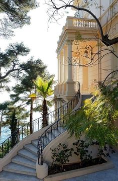 the stairs lead up to an elegant building