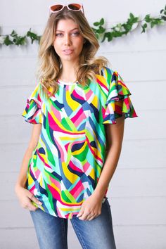 Refresh your casual closet while adding a touch of fun with this short, double ruffle frill sleeve top with a contrasting navy merrow hem. The eye catching multicolor geometric print design completes this top. Vendor: Haptics Jess would wear a size Large Geometric Print + Flutter Sleeves with Merrow Hem Woven - Non Stretch 100% POLYESTER Designed in California Imported Runs True to Size Weight: .3 lb; plus weight .4 Lb Bust (side to side): S 20" M 21" L 22" 1X 24" 2X 25" 3X 26" Length (shoulder Colored Denim Jeans, Bubble Sleeve Top, Frill Sleeves, Wide Leg Linen Pants, Flutter Sleeve Top, Woven Top, Flutter Sleeves, Sweater And Shorts, Crochet Designs