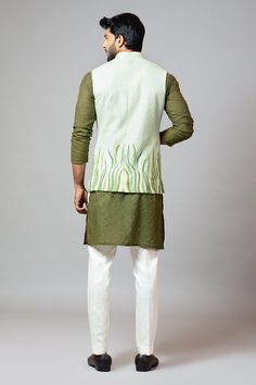 Sea green bundi with grass pattern embroidered and patch pocket. Paired with Chanderi olive green short kurta and churidar.
Component: 3
Embroidered
Neckline: Band
Sleeve Length: Three quarter
Fabric: Bam Silk, Chanderi, Malai Cotton
Color: Green
Note: Pocket square worn by the model is not for sale - Aza Fashions Grass Pattern, Kurta Set For Men, Short Kurta, Olive Green Shorts, Luxury Sale, Nehru Jackets, Embroidered Neckline, Churidar, Kurta Set