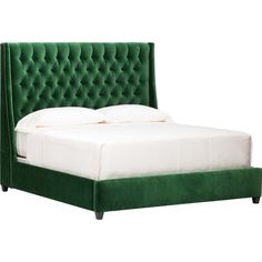 a bed with green velvet headboard and white linens on the foot board, in front of a white background