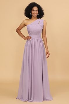 a woman in a purple dress posing for the camera with her hands on her hips