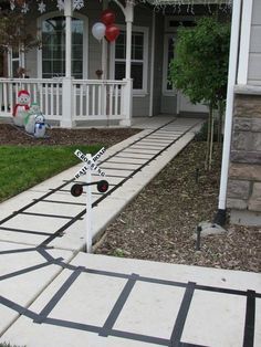 a railroad crossing in front of a house