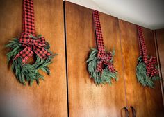 two christmas wreaths are hanging on the wall