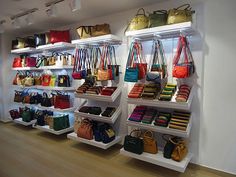 several shelves with purses and handbags on them