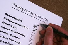 a person is filling out their new home checklist