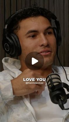 a man wearing headphones and holding a microphone in front of him with the words love you on it