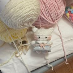 two balls of yarn are next to a stuffed animal