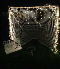 a lighted net with lights on it in the grass