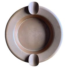 an empty plate with two spoons on the top and one in the middle, against a white background