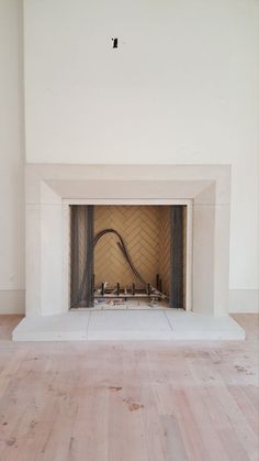 an empty room with a fire place in it