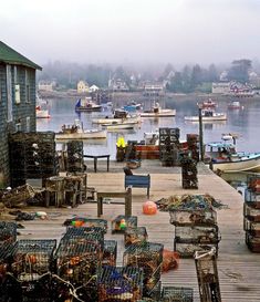 several lobster cages are stacked on a dock