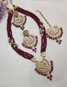 Ruby Red Kundan Necklace Set With Earrings And Tikka, Indian Jewelry, Bollywood Jewelry, Sabyasachi Inspired Jewelry, Bridal Necklace Set * Necklace Length: 24 inches (comes with adjustable sarafa/dori/cord) * Earrings Length: 3 inches approx * Maang Tikka: Freesize * Material: Copper, Kundan * Package: Necklace, Earrings and Maang Tikka STYLE TIP: The Look Is Stunning And Perfectly Suitable For All Kinds Of Dressy Occasions. Wear with an ethnic outfit for any occasion. This traditional set can Red Bridal Necklace With Latkans For Celebration, Red Bridal Necklace With Latkans For Diwali, Red Kundan Necklace Hand Set For Festivals, Red Bollywood Bridal Necklace With Latkans, Red Round Meenakari Bridal Necklace, Red Meenakari Round Bridal Necklace, Red Meenakari Bridal Necklace, Traditional Red Round Kundan Necklace, Red Chandbali Bridal Necklace For Celebration