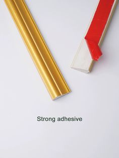 two gold and red pencils with the words strong adhesivee written below them