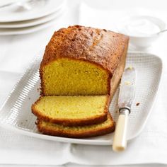 a loaf of lemon bread on a plate with a knife