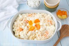 a bowl filled with rice and fruit next to two bowls full of marshmallows