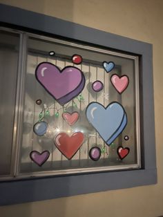 a window with hearts painted on it