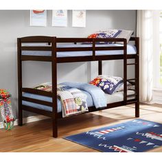 a bunk bed with blue sheets and pillows on it in a child's bedroom