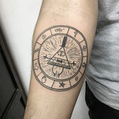 a man's arm with a tattoo on it that has an all seeing triangle