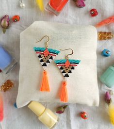 Orange, Gold and Turquoise Triangle Miyuki Earrings with Neon Orange Tassel ☀️🌸💃 Part of each sale will be donated to animals without a home in Turkey ❤️ 🐶🐱 This is a perfect gift for yourself, your friends or family.  The earrings are made of Miyuki beads and cotton tassels. The closures are gold colored earwires. The earrings measure 7,3 cm from the top of the earwire to the bottom of the tassel.  All orders are packed in padded envelopes to ensure safe delivery. Please send a message if y Beaded Earrings Orange, Beadwork Designs, Seed Beading, Miyuki Beads, Neon Orange, Small Earrings, Seed Bead Earrings, Tassel Earrings, Handmade Earrings