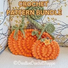 two crocheted pumpkins sitting next to each other on top of a couch