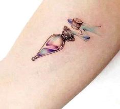 a woman's arm with a tattoo on it that has an hourglass in it