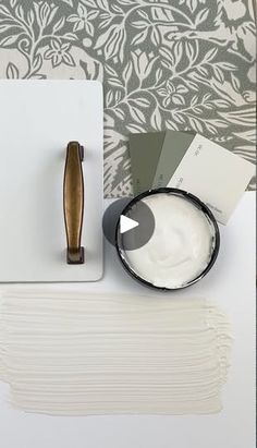 the paint is being used to create a wallpaper design with white and green tones