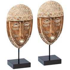 two wooden masks on black stands with white background