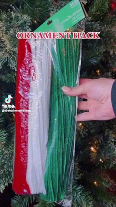 a package of green and white string on top of a christmas tree with the flag of italy