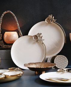 a table topped with lots of white plates