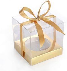 a clear box with a gold ribbon around it