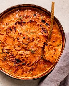 a casserole dish is shown with a spoon in it