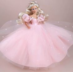 a barbie doll wearing a pink ball gown