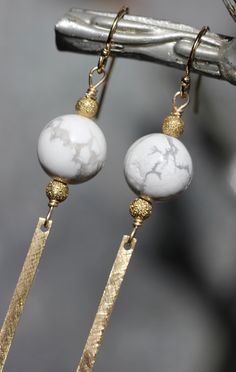 "White howlite stones are accented with raw brass beads and a bar drop with a brushed texture, which dangles below the stone. While most of the components are made out of brass, the wire work and ear wires are gold filled. The howlite stone measures 10mm in diameter. The earring drop measures 68mm (little over 2 1/2\")." Silver Tassel Earrings, Brass Bar, Howlite Stone, Brass Beads, White Howlite, Bar Earrings, Herkimer Diamond, Wire Work, Rutilated Quartz