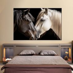 two horses standing next to each other on a wall above a bed in a bedroom