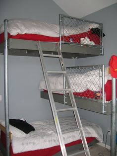 bunk beds with red pillows and white blankets