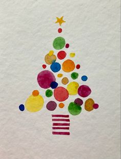 a christmas tree made out of colored circles on white paper with gold stars and confetti