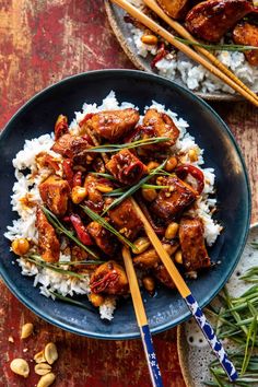 chicken and cashew stir fry served on rice with chopsticks