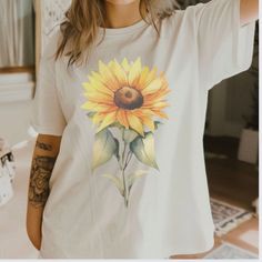 Sunflower Shirt, Flower Shirt, Spring Sunflower tshirt, Garden Shirt, Sunflowers Gift for her, Wildflower tee, Flower Print Tee size S-4X Step into spring with our vibrant unisex sunflower shirt, perfect for garden lovers and fashion enthusiasts alike! Made from eco-friendly, soft, breathable cotton, this tee boasts a bold, eye-catching flower print design. Ideal for gardening, casual wear, or festive occasions, it's a versatile addition to any wardrobe. Available in multiple sizes, this sunflow Cotton Crew Neck T-shirt With Sunflower Design, Cotton Short Sleeve T-shirt With Sunflower Print, White Floral Print Summer T-shirt, White Botanical Shirt For Summer, Yellow Plants Print Short Sleeve T-shirt, Yellow Graphic Tee With Floral Print, Yellow Short Sleeve T-shirt With Plant Print, Yellow T-shirt With Plant Print For Summer, Summer Floral Print Top