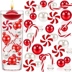 a red candle surrounded by candy canes and balls