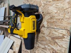 a cordless drill is attached to a piece of plywood