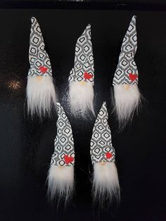 four white and red gnome hats with feathers