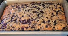 a pan filled with blueberry cake sitting on top of a stove