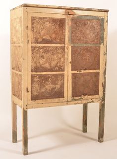 an old wooden cabinet with several compartments on the front and bottom, sitting against a white background