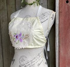 an ivory linen and cotton halter top featuring an embroidered mauve orchid  gently elasticised under the front SIZE approx small / medium mannequin is a size small gentle wash Cropped Halter Top, Womens Blouses, Halter Crop Top, Easy Sewing, Halter Top, Cotton Linen, Womens Clothing Tops, Orchids, Beauty Book