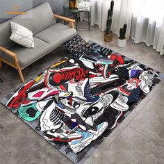 a living room with a couch and rug covered in cartoon art on the floor next to a chair