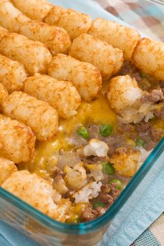 a casserole dish with tater tots and meat in it, ready to be eaten