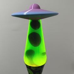 a green and purple vase sitting on top of a table