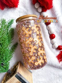 a jar with gingerbread cookies on it next to other decorations